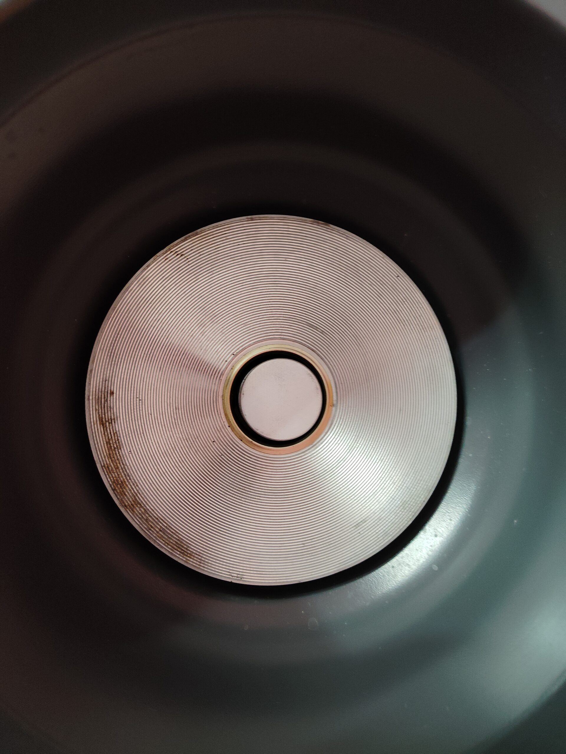 Clean and well-maintained electric rice cooker internal heating plate showing minimal wear after months of daily cooking.